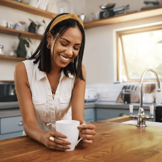 woman relaxing in the kitchen with coffee | meal support coaching program in california online therapy | body image issues | eating disorder treatment | Orange County 92806 | San Francisco 94188| Pasadena 91199